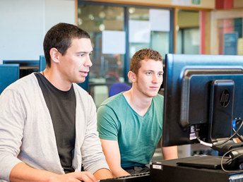 A group of students looking at a computer screen