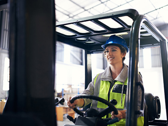 A woman driving a forklift