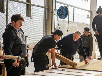 UCOL construction students and lecturer working at the workshop