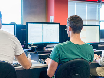 Three men learning at the UCOL computer lab.